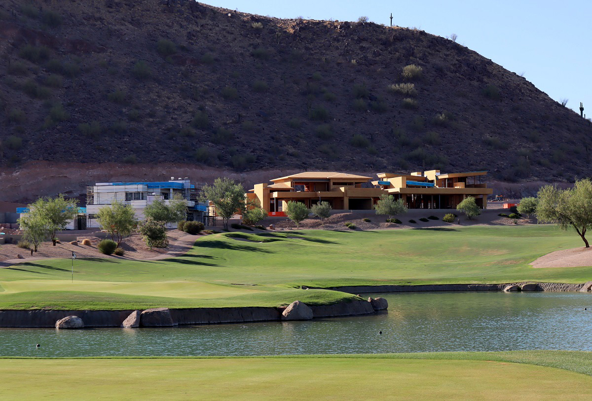 Photo of homes under construction on a golf course.