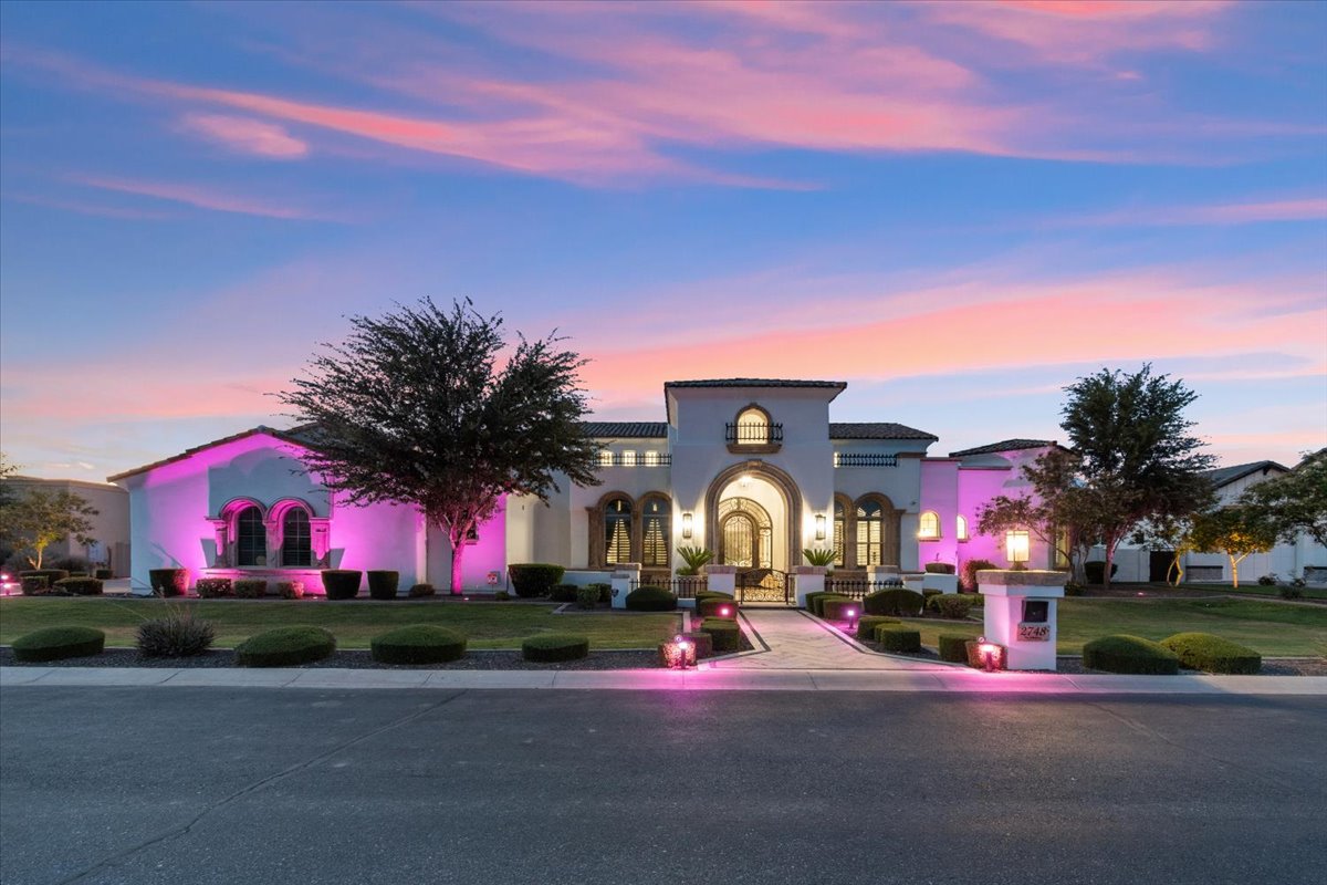 The front a of stunning luxury home at sunset.