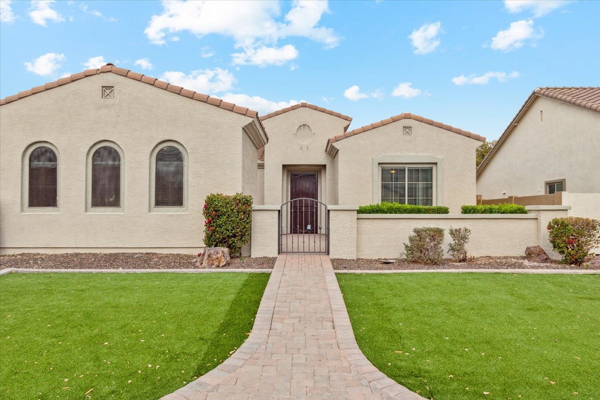Exterior of a single family home and green lawn.