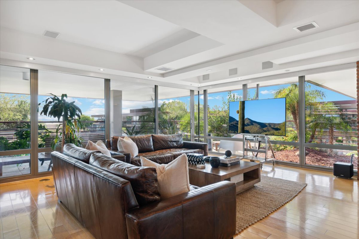 A couch and flatscreen TV adorn a luxury condo's living room.