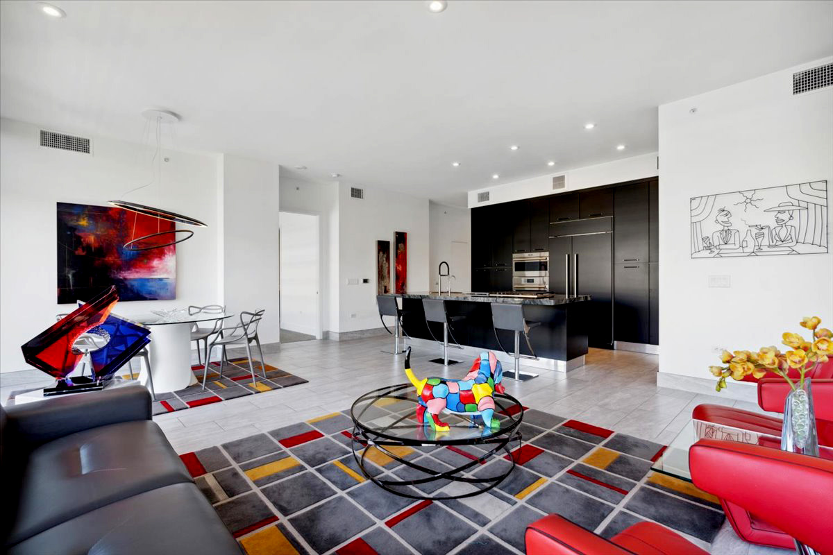 A couch and flatscreen TV adorn a luxury condo's living room.