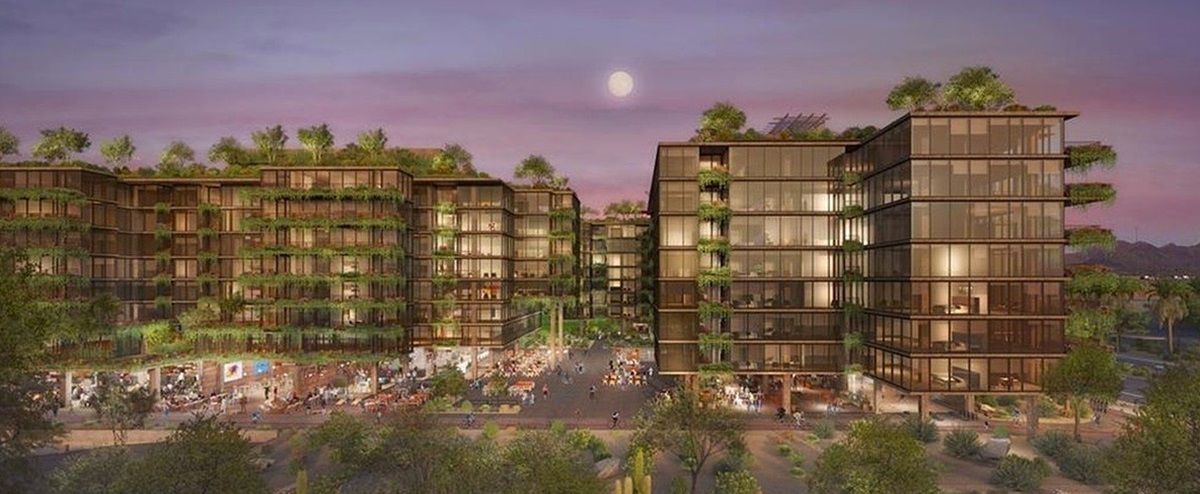 Rendering of Optima McDowell Mountain Village, a luxury residential complex with multiple glass buildings, lush greenery, and a bustling central plaza.