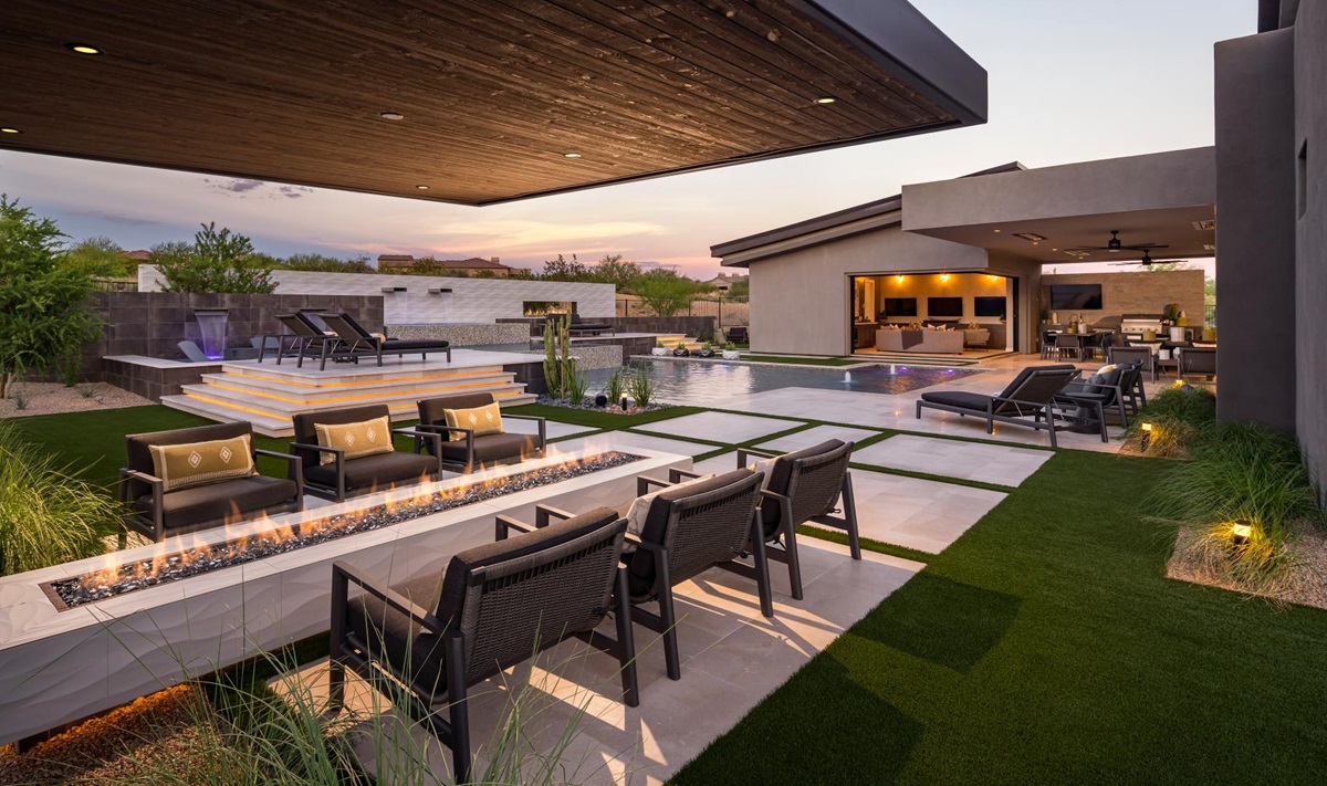 Luxurious outdoor space with a fire pit, pool, and covered patio for relaxing.
