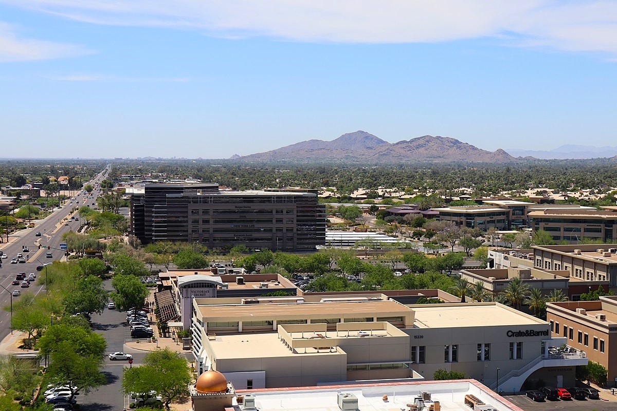 Aerial view of Scottsdale’s business district, featuring office buildings and Camelback Mountain in the distance.