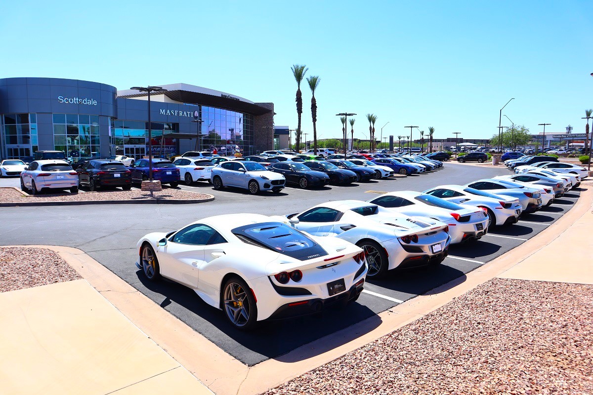 Luxury cars, including Maseratis and Ferraris, lined up outside the Scottsdale Maserati dealership.