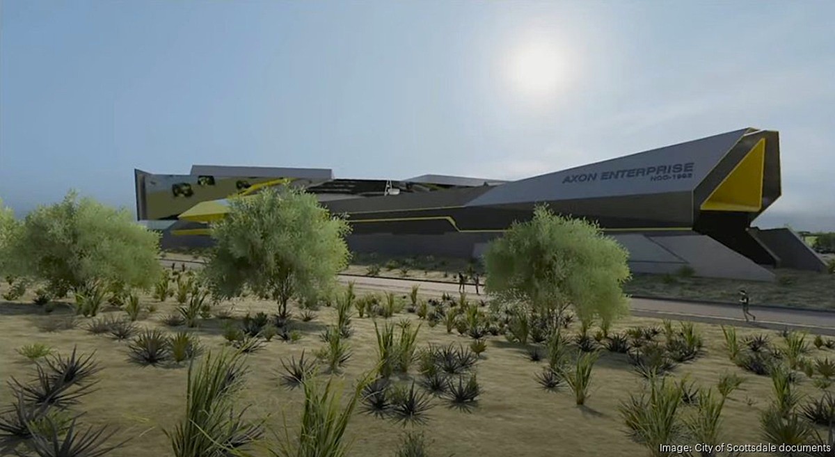  Rendering of the futuristic Axon Enterprise headquarters in North Scottsdale, featuring a sleek, spaceship-inspired design surrounded by desert landscaping and native vegetation.