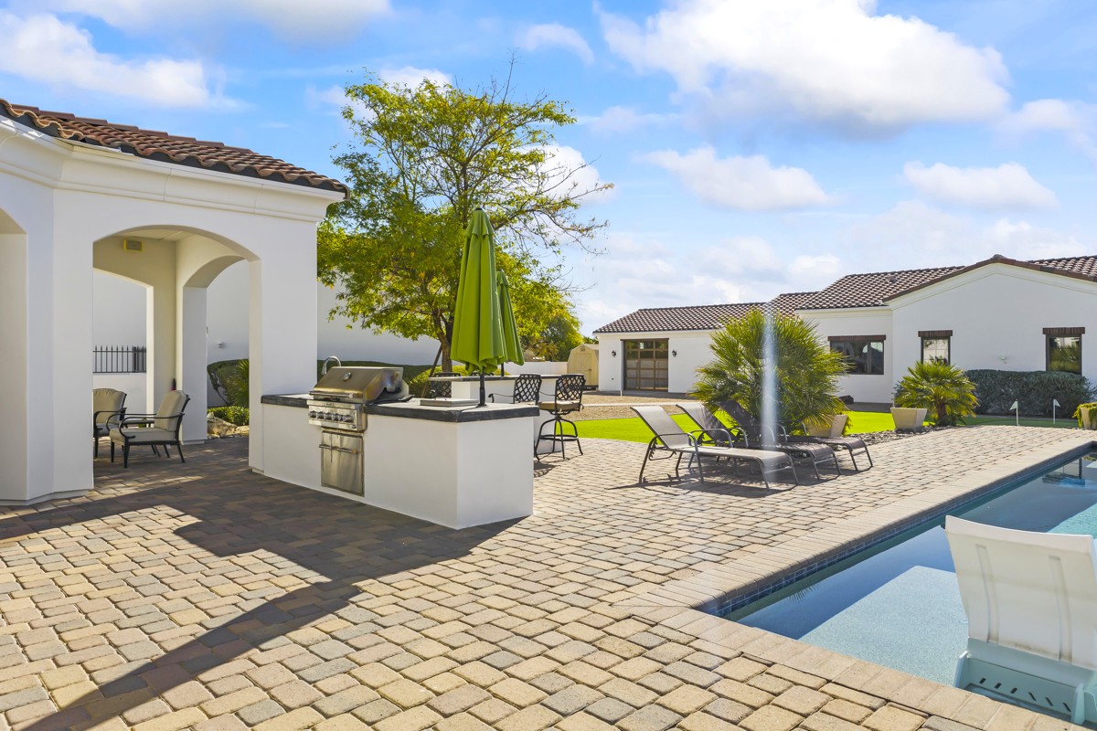 The backyard and pool of a sprawling custom home property in the Cactus Corridor.