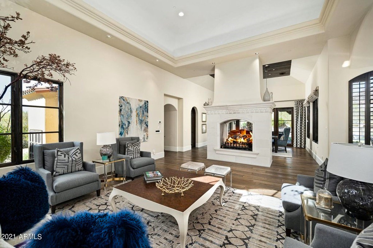 Spacious living room featuring a large fireplace, cozy seating, and stylish decor.