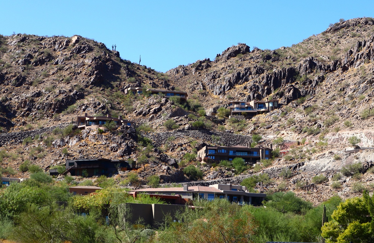 Hillside homes built into rugged desert mountains in Arizona.