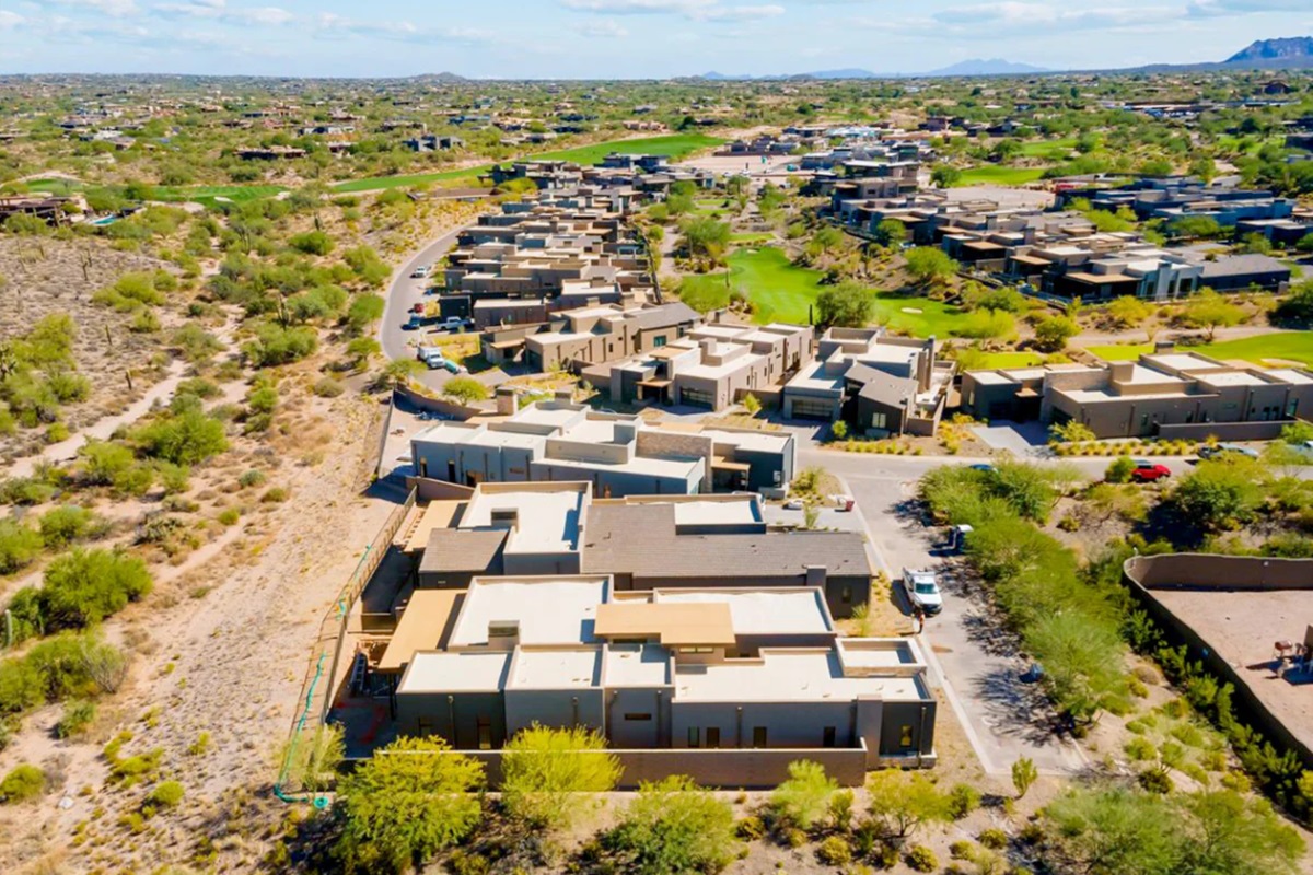 Aerial view of a modern Scottsdale neighborhood with unique desert architecture and lush landscaping.
