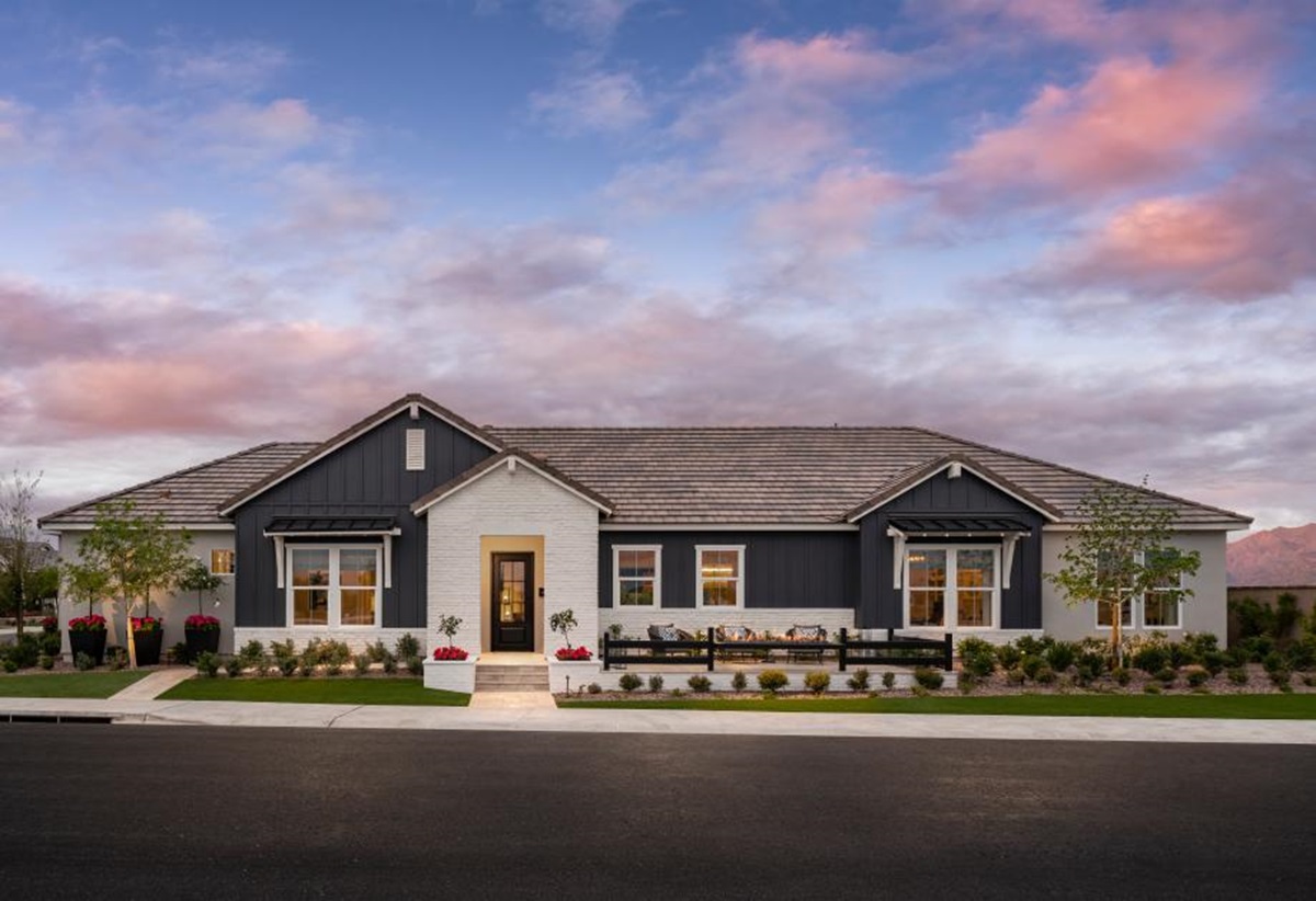 Modern farmhouse-style home with dark siding and white brick accents at Sterling Grove in Surprise, AZ.