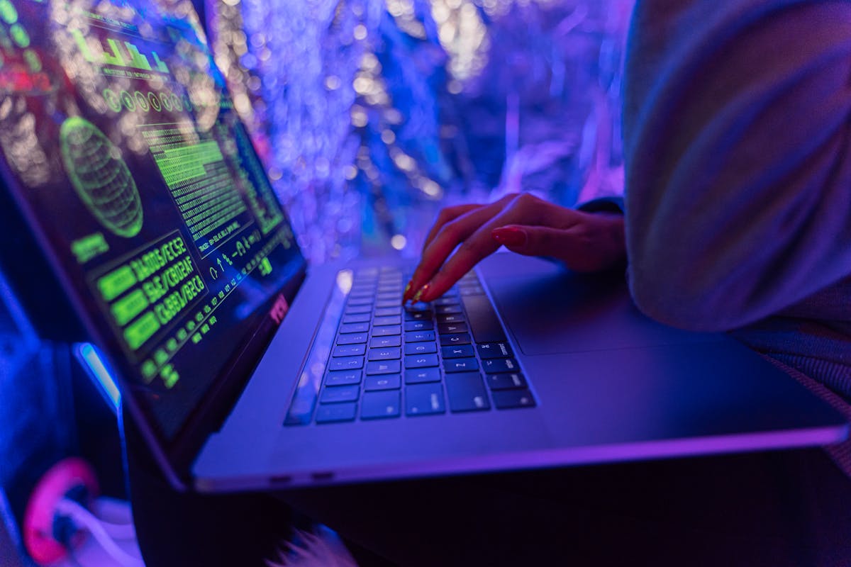 A hand on a laptop computer.