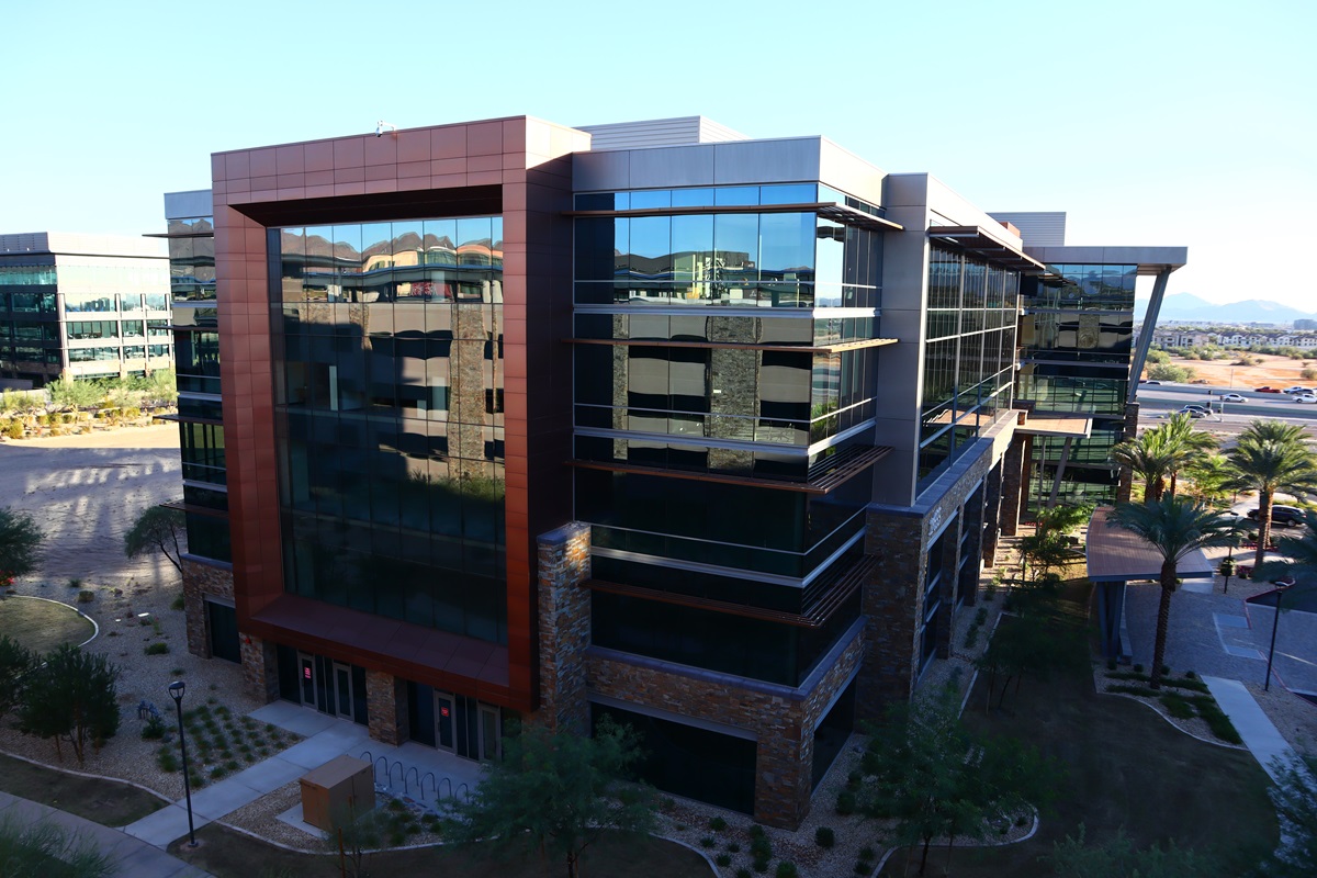 A sleek, modern office building exemplifies Scottsdale’s growth as a hub for businesses and innovation, with contemporary architecture and well-maintained landscaping.