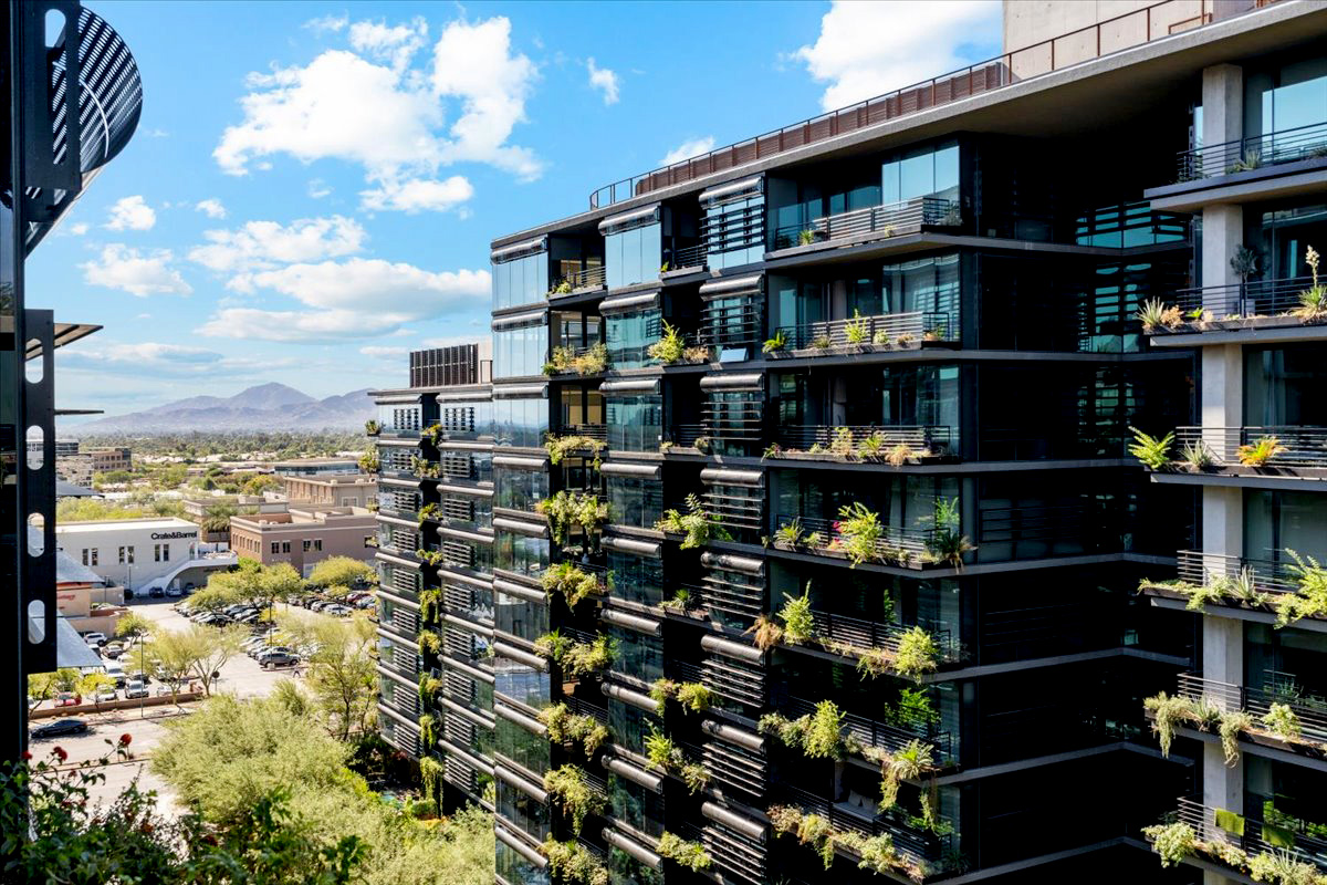 Modern condos in Scottsdale with greenery on the balconies.