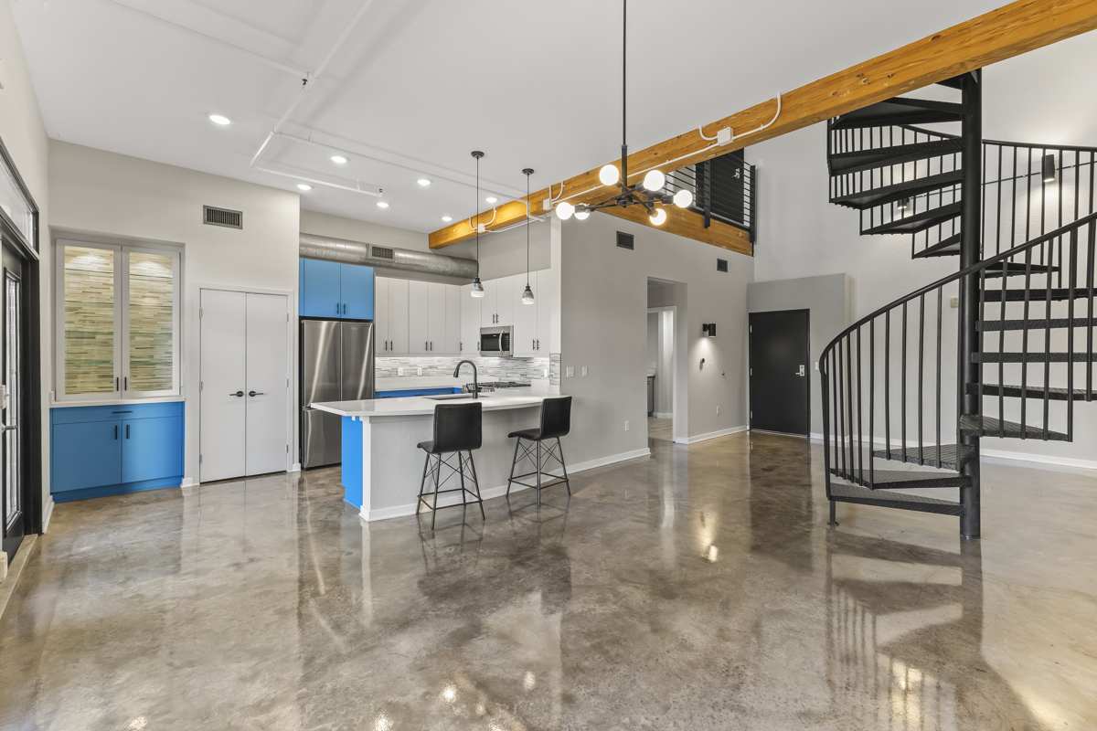 Modern kitchen with blue cabinets, stainless steel appliances.