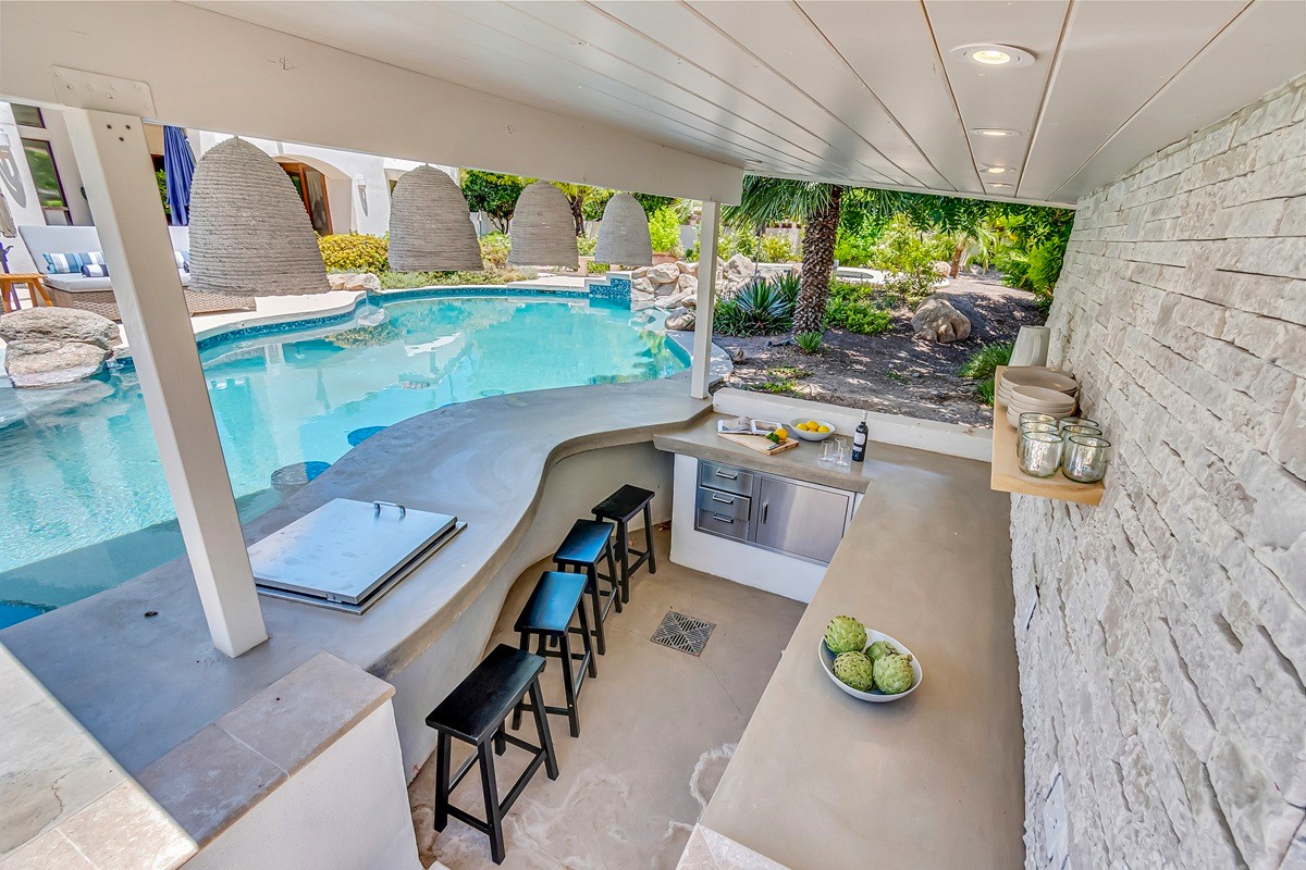 Backyard patio and pool of an investment property in Arizona on a sunny blue-skied day.