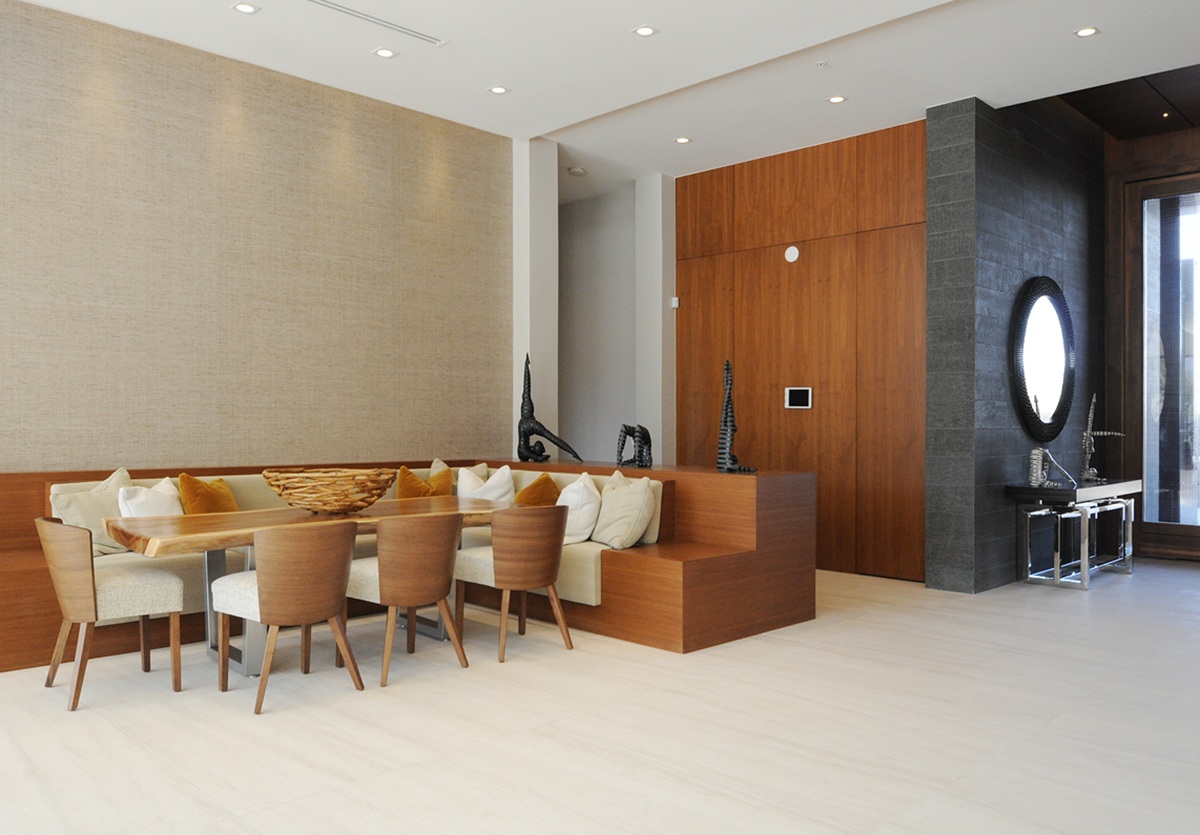 Elegant dining area with wooden table, cushioned bench, and chairs.