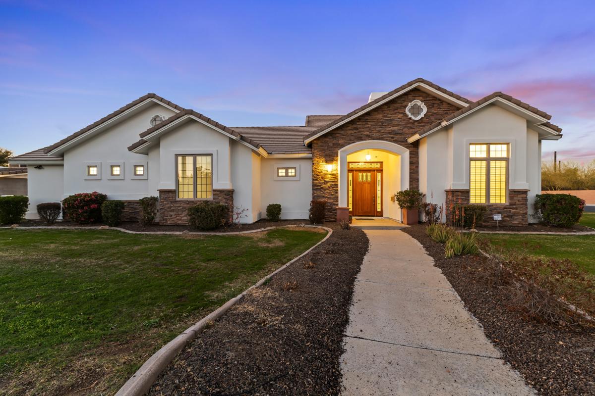 A luxury home in Central Phoenix seen from out front at dusk.