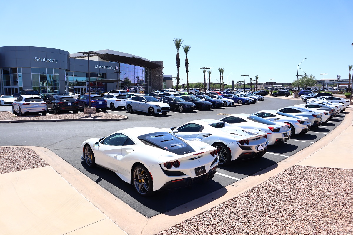 A row of white Maseratis are seen at the Scottsdale dealership on a sunny day.