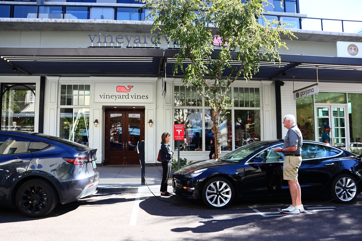 Street-level view of Scottsdale Quarter with Tesla charging and Vineyard Vines storefront.