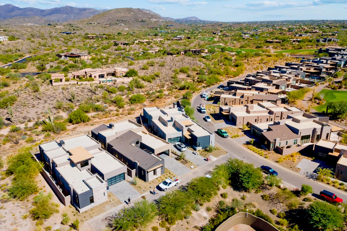 Sweeping aerial of Desert Mountain neighborhood winding through the Sonoran Desert in Scottsdale.