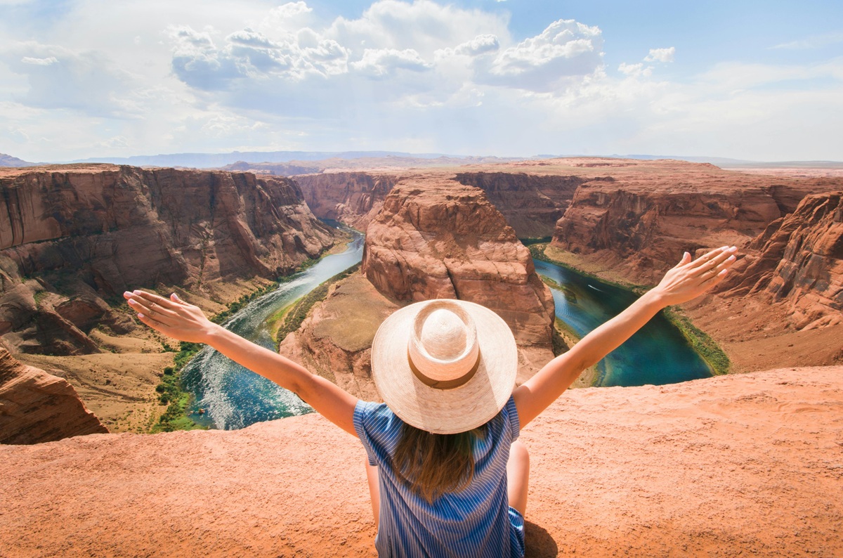 Woman overlooking Horseshoe Bend and the Colorado River in Arizona.