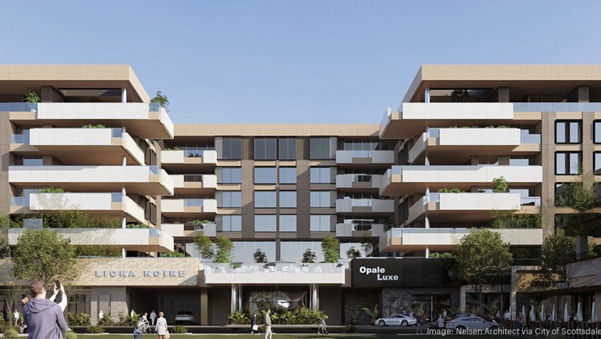 Contemporary mid-rise condo project with boxy balconies and modern architecture, viewed from the street level.