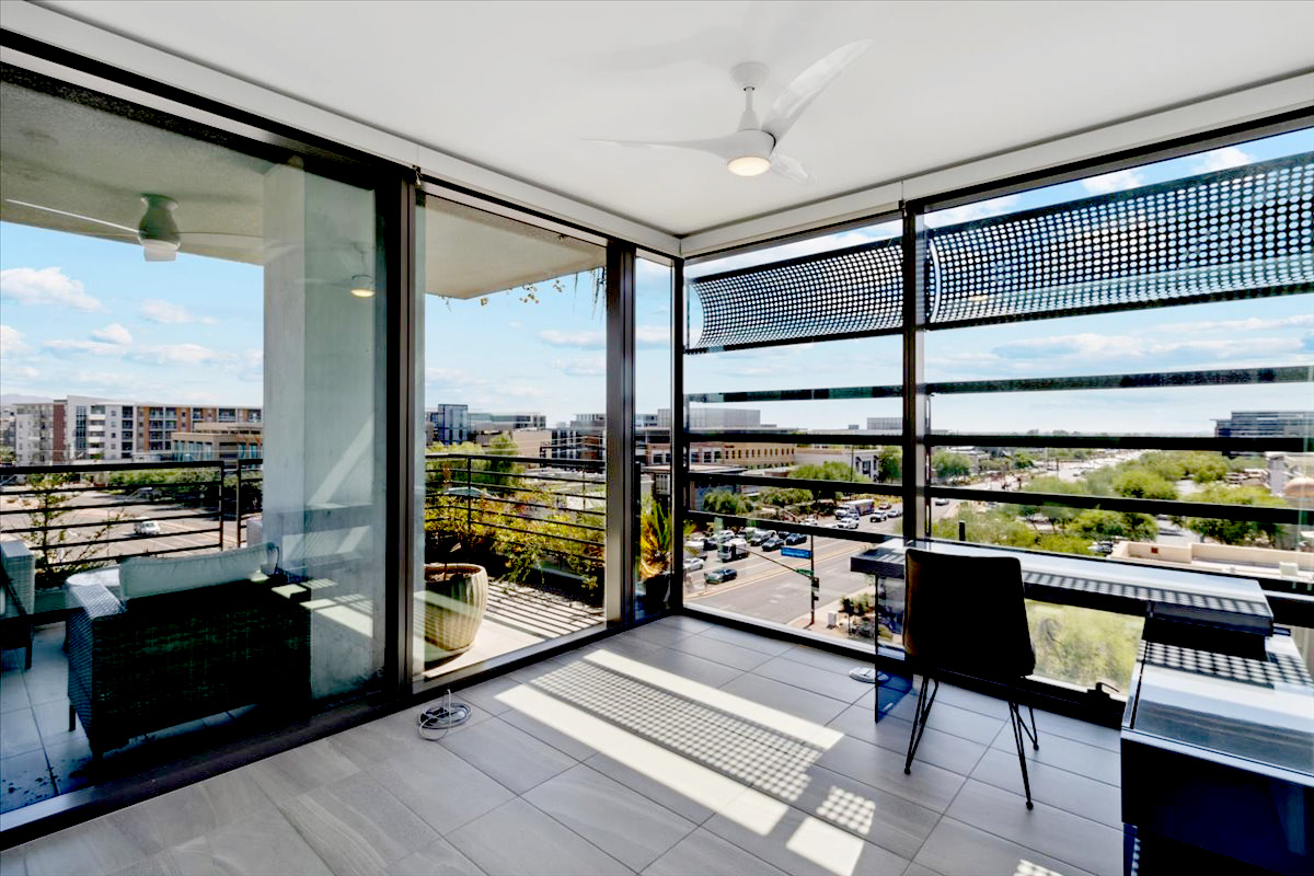 Modern corner unit with floor-to-ceiling windows and panoramic city views.