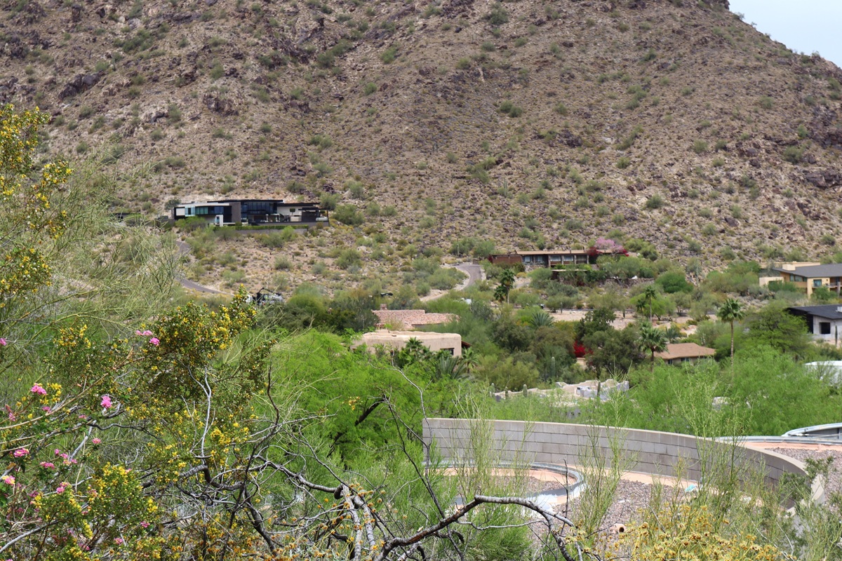 Desert hillside homes in Paradise Valley surrounded by rocky terrain and sparse vegetation.
