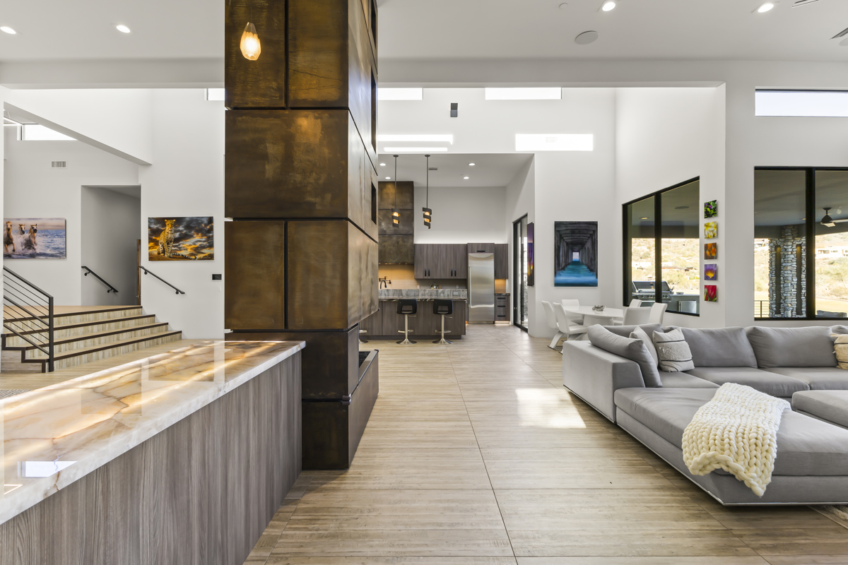 Modern open-concept Scottsdale living room with sleek finishes, gourmet kitchen, and contemporary art.