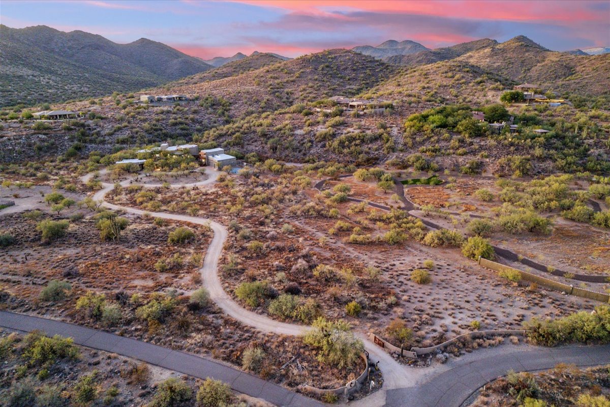 Aerial view of a desert residence among cacti and rocky hills