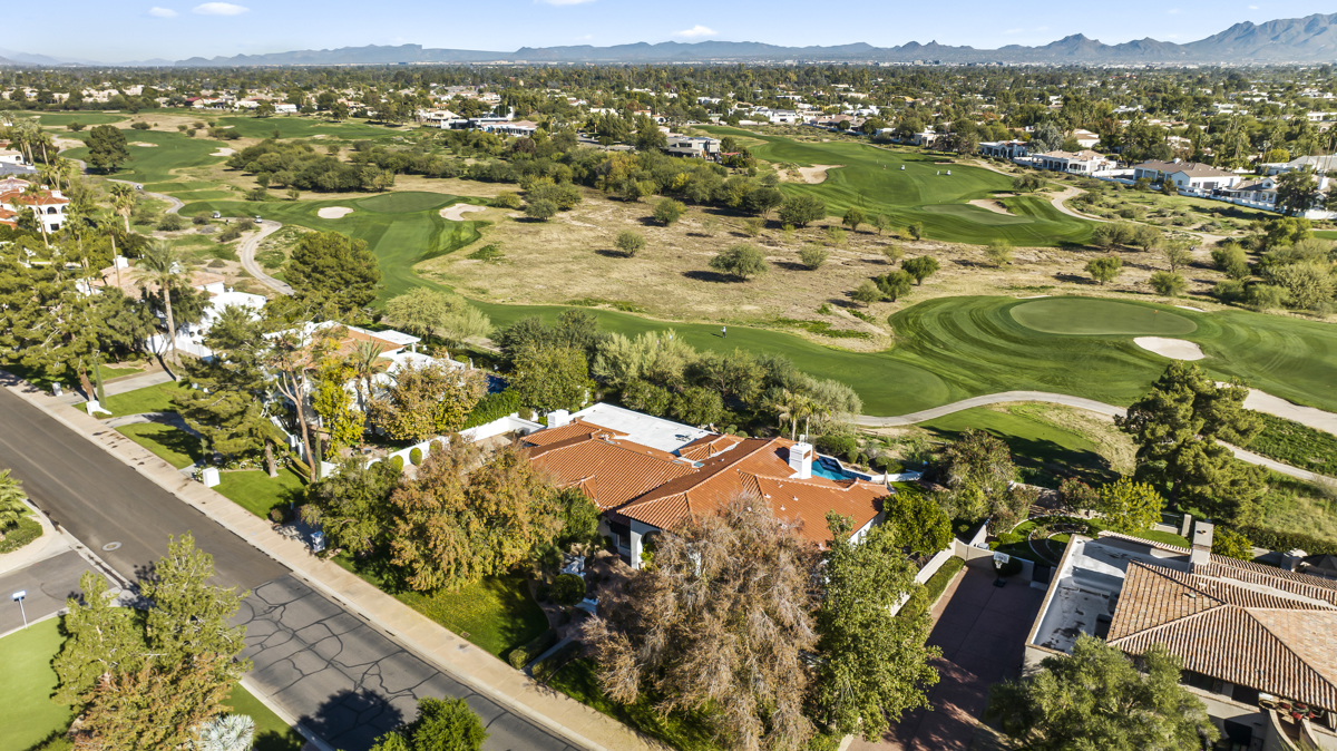Aerial view of homes bordering a lush golf course in Arizona.