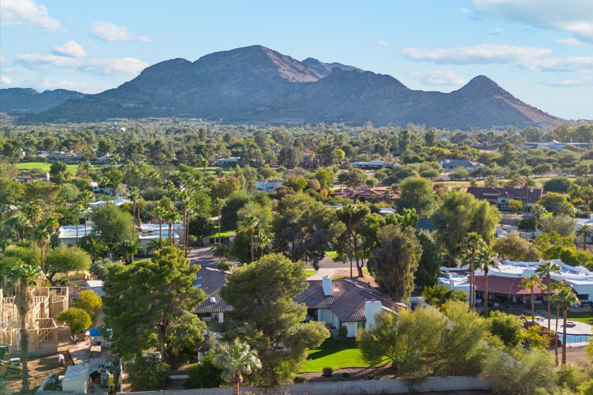 Residential neighborhood with mountain views and mature trees.