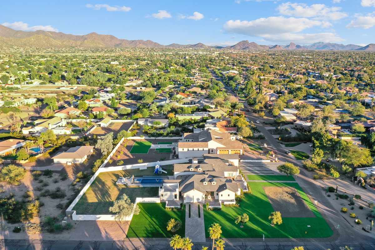 Aerial view of a residential neighborhood with desert landscaping and mountains in the Greater Phoenix metro area.