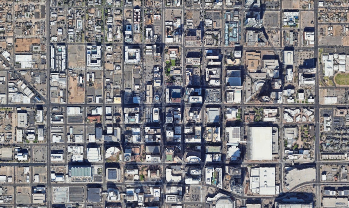 Aerial view of downtown Phoenix with a grid of streets and tall buildings.