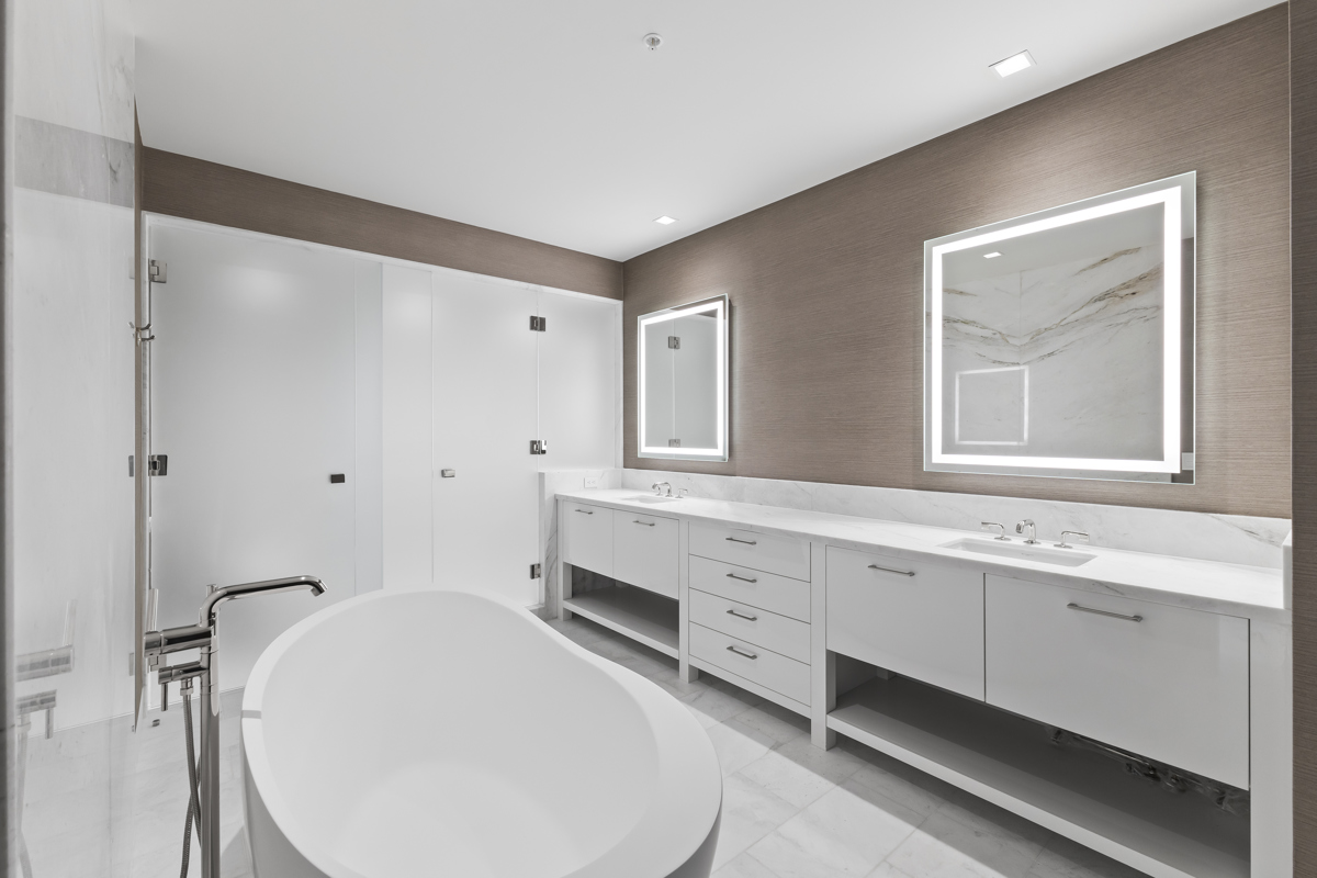 Modern luxury villa bathroom with freestanding tub and double vanity.