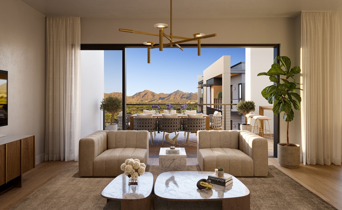 Bright, contemporary living space with neutral furniture, large sliding glass doors, and a balcony overlooking desert mountains.