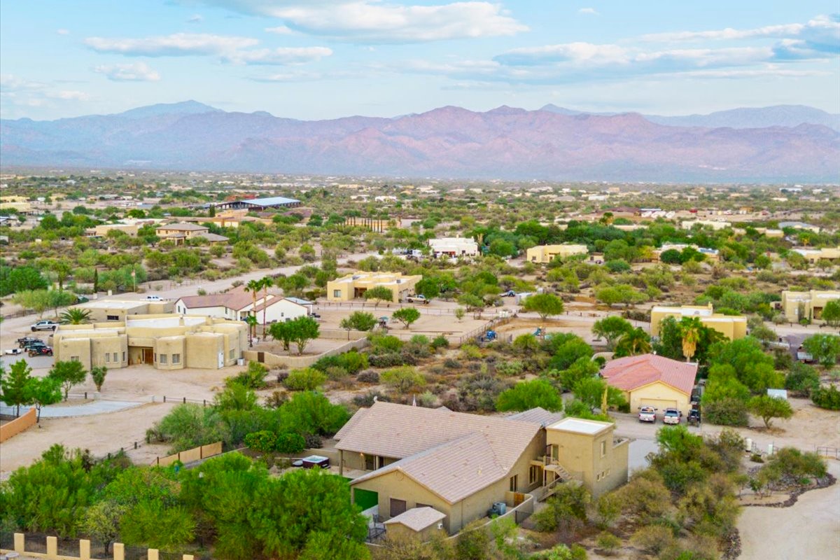 Aerial view of desert homes with mountain views in Greater Phoenix.