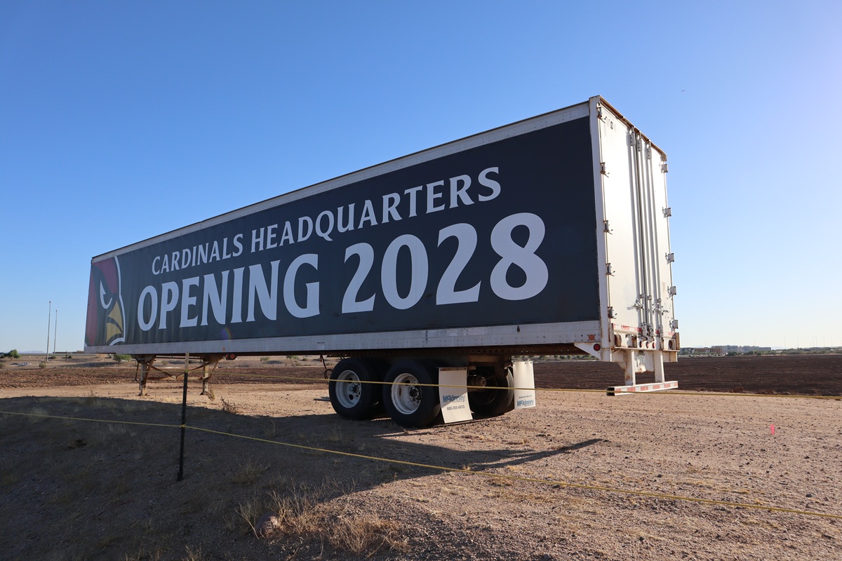 Sign announcing the Arizona Cardinals' new headquarters and training facility opening in 2028 in north Phoenix.