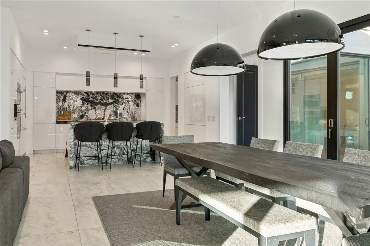 Contemporary luxury kitchen and dining area with marble accents.