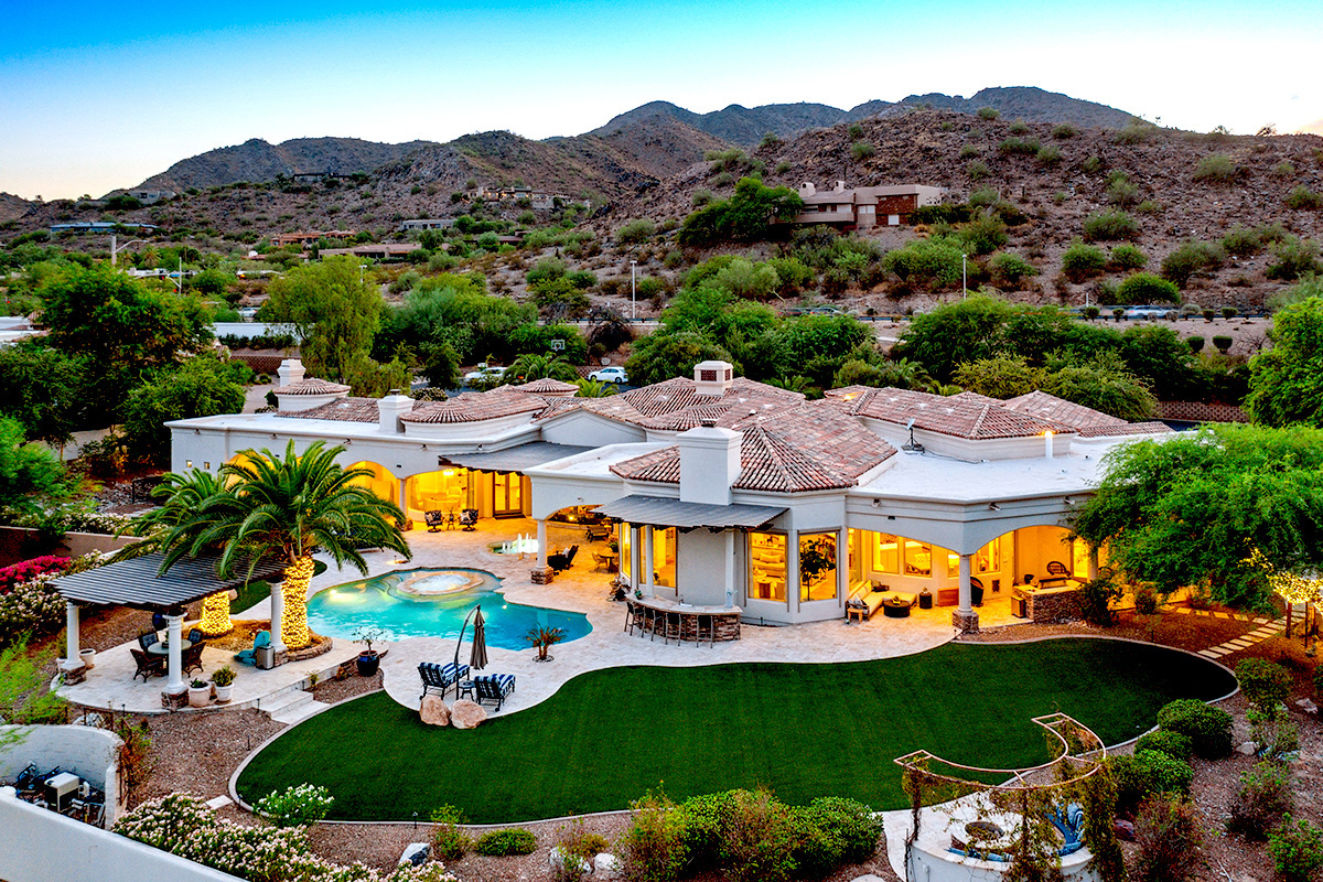 Twilight aerial of a luxury Paradise Valley estate with mountain views