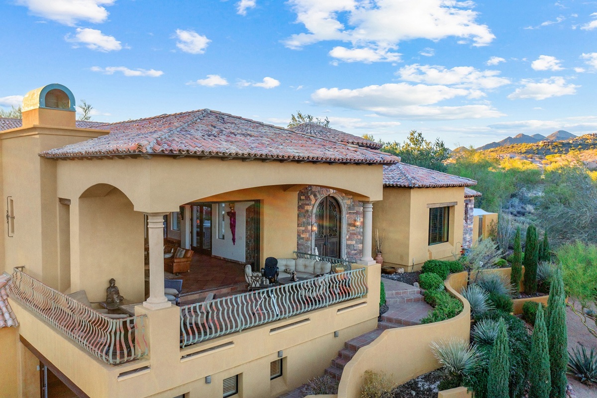 A luxury Arizona home surrounded by desert landscaping and mountain views.