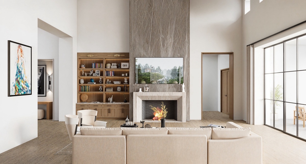 A bright high-end great room with a fireplace, built-in shelving, and large windows.