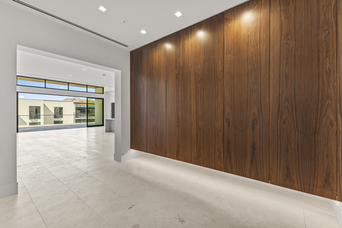 Modern luxury interior with a dramatic wood accent wall.