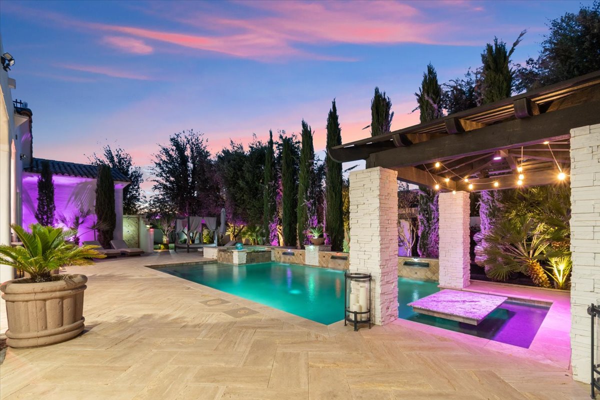 Resort-style pool with dramatic evening lighting.