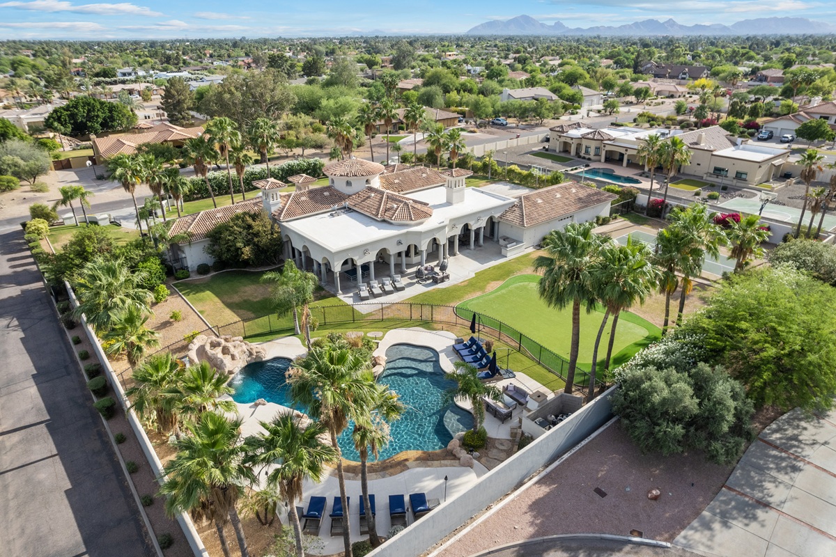 Aerial view of a luxury Greater Phoenix home with a pool and landscaped backyard.