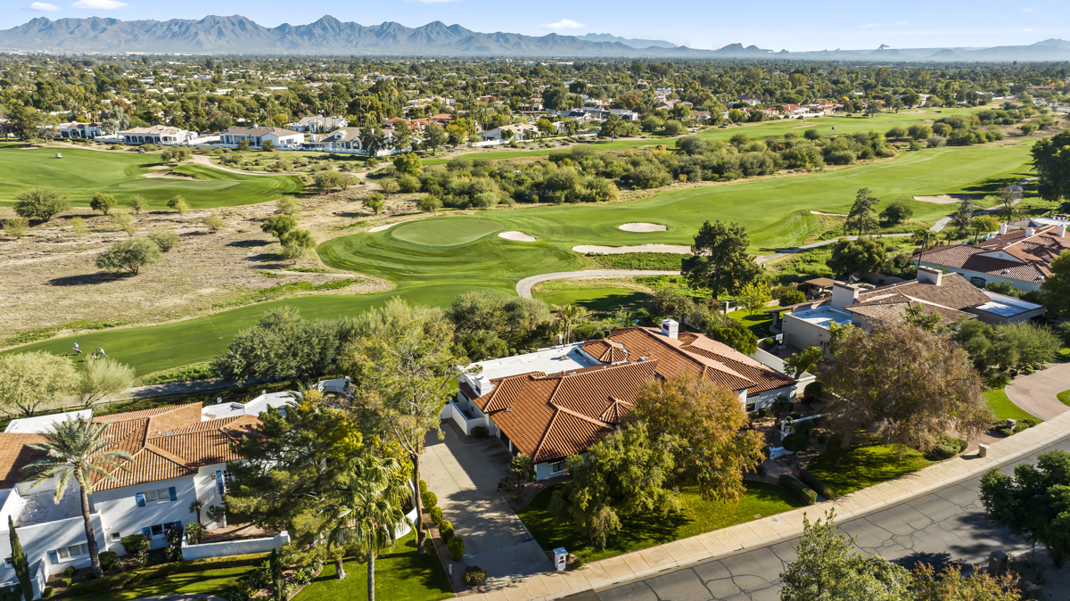 Aerial photo of Paradise Valley homes overlooking a golf course and mountain views.