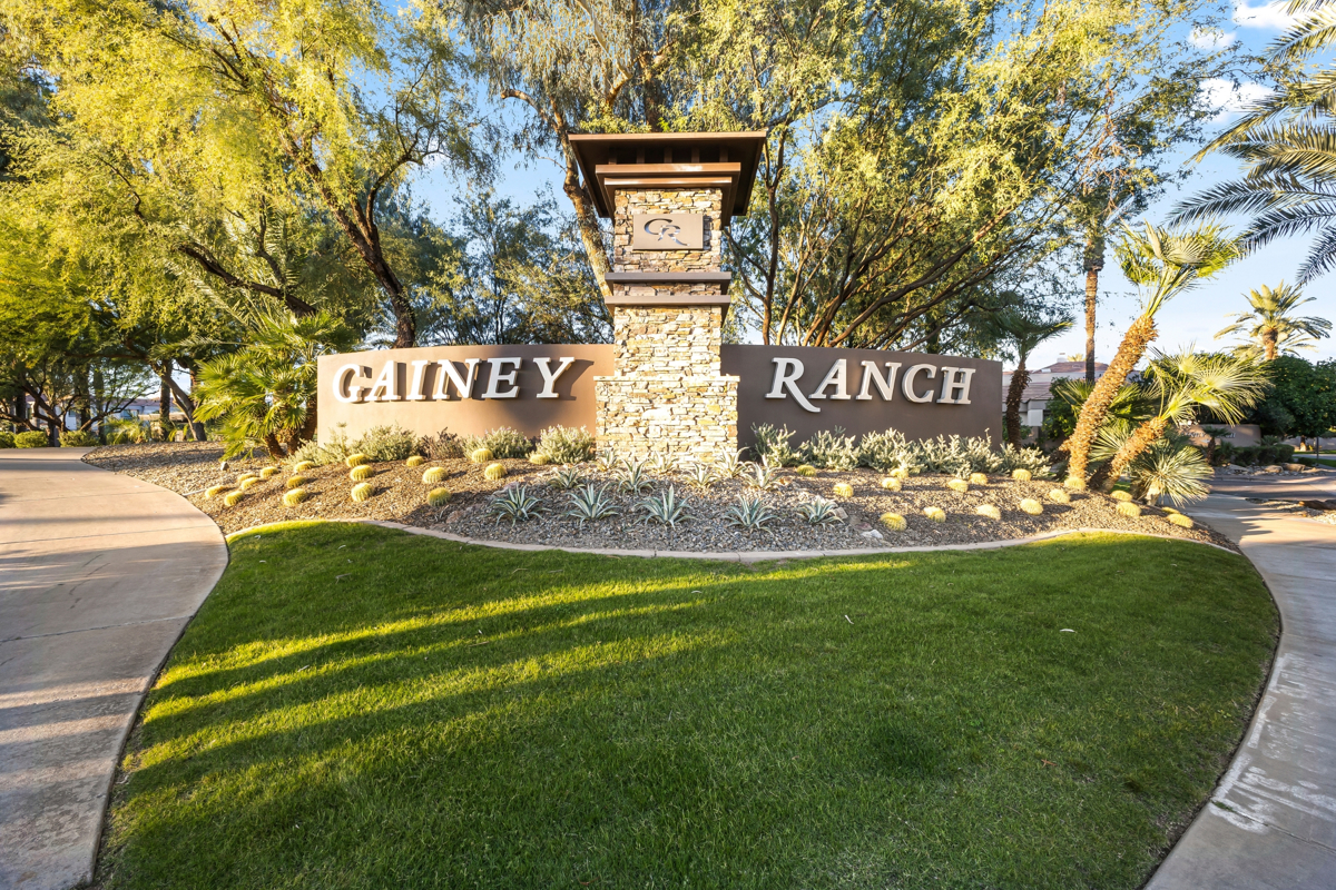 Gainey Ranch entrance monument with desert landscaping and mature trees in Scottsdale.