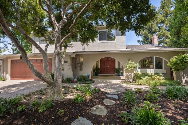 Traditional single-family home in The Willows neighborhood of Menlo Park, California, featuring mature trees, landscaped grounds, and a covered front entry.