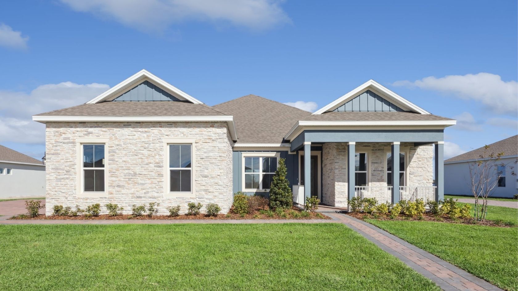 Florida New Construction Home with In-Law Suite New construction multigenerational home Florida stone exterior